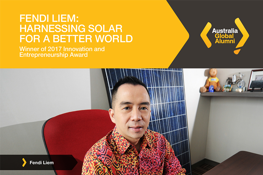 A man wearing colorful batik shirt sitting on the red office chair